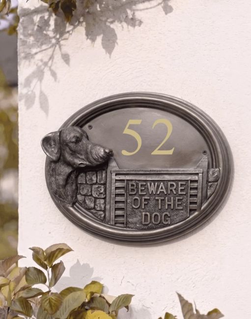 A Number 43 Doberman House Number Sign in a Bronze Finish Mounted on a Cream Coloured Cottage Wall - Digital Illustration A Number 43 Doberman House Number Sign in a Bronze Finish Mounted on a Cream Coloured Cottage Wall - Digital Illustration