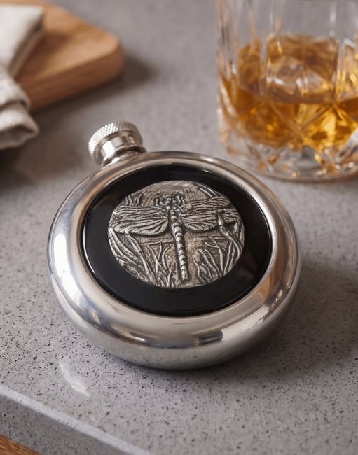 The Dragonfly Whiskey Flask next to a Decorative Glass Tumbler with Whisky - Digital Illustration The Dragonfly Whiskey Flask next to a Decorative Glass Tumbler with Whisky - Digital Illustration