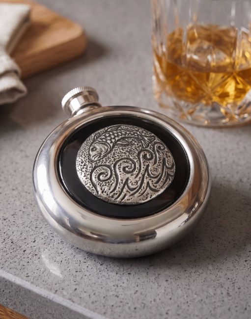The Fish Whiskey Flask next to a Glass of Scotch on a Grey Countertop - Digital Illustration The Fish Whiskey Flask next to a Glass of Scotch on a Grey Countertop - Digital Illustration
