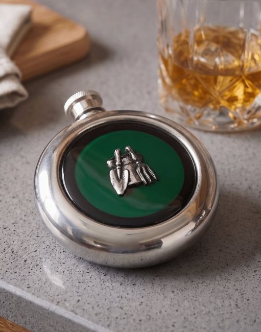 The Gardeners Whiskey Flask on a Kitchen Work Surface next to a Glass of Scotch - Digital Illustration