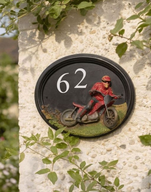 A Number 87 Hand Painted "Macio Motocross" House Sign Mounted on a Sunny Cottage Wall - Digital Illustration A Number 87 Hand Painted "Macio Motocross" House Sign Mounted on a Sunny Cottage Wall - Digital Illustration