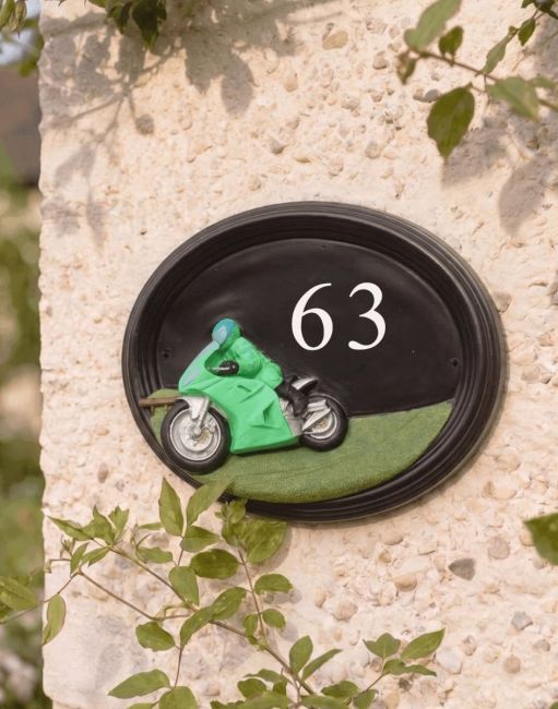 A Number 70 Hand Painted Sport Touring Motorbike House Sign Mounted on a Cream Coloured Sunny Cottage Wall - Digital Illustration