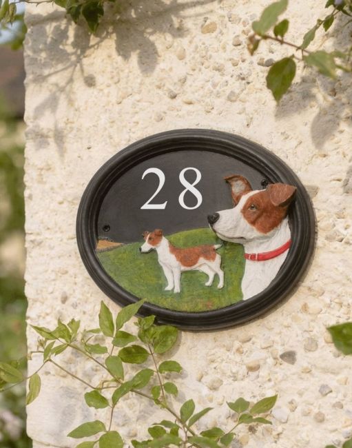 A Number 28 Hand Painted Jack Russell House Sign Mounted on a Cream Coloured Cottage Wall - Digital Illustration A Number 28 Hand Painted Jack Russell House Sign Mounted on a Cream Coloured Cottage Wall - Digital Illustration