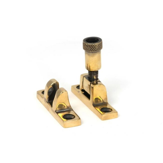 The Knurled Brighton Sash Square Window Fastener - Aged Brass on a White Background 