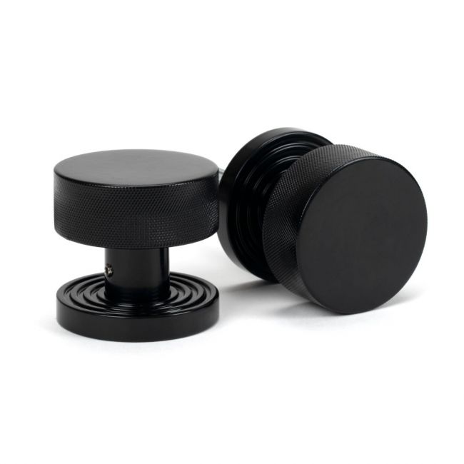 The Knurled Mortice/Rim Knob Set on a Beehive Rose in Black Shown Upright and on its Side The Knurled Mortice/Rim Knob Set on a Beehive Rose in Black Shown Upright and on its Side