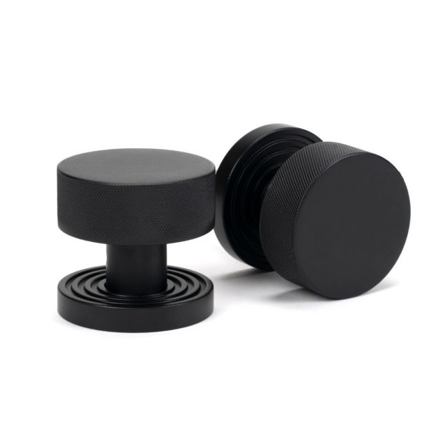 The Knurled Mortice/Rim Knob Set on a Beehive Rose in Matt Black Shown Upright on a White Background The Knurled Mortice/Rim Knob Set on a Beehive Rose in Matt Black Shown Upright on a White Background