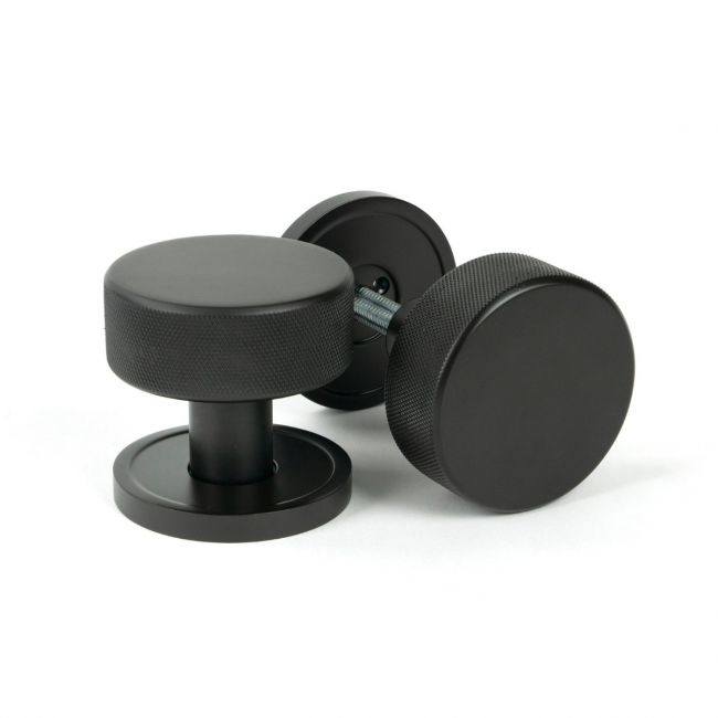 The Knurled Mortice/Rim Knob Set on a Plain Rose in Aged Bronze The Knurled Mortice/Rim Knob Set on a Plain Rose in Aged Bronze