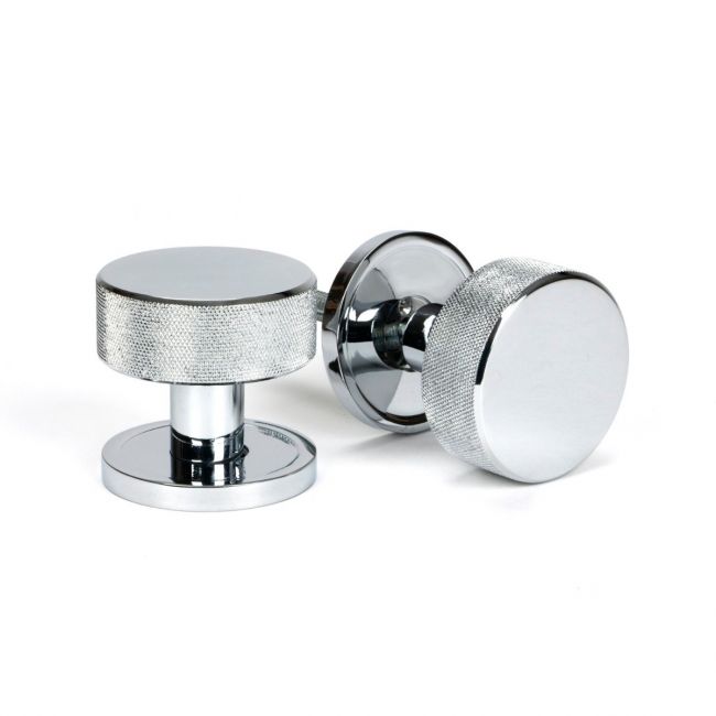 The Knurled Mortice/Rim Knob Set on a Plain Rose in Polished Chrome Shown Upright and on its Side on a White Background The Knurled Mortice/Rim Knob Set on a Plain Rose in Polished Chrome Shown Upright and on its Side on a White Background