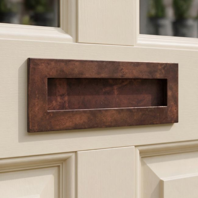 The Large Horizontal Letter Plate in a Bronze Finish on a White Coloured Front Door - Digital Illustration The Large Horizontal Letter Plate in a Bronze Finish on a White Coloured Front Door - Digital Illustration