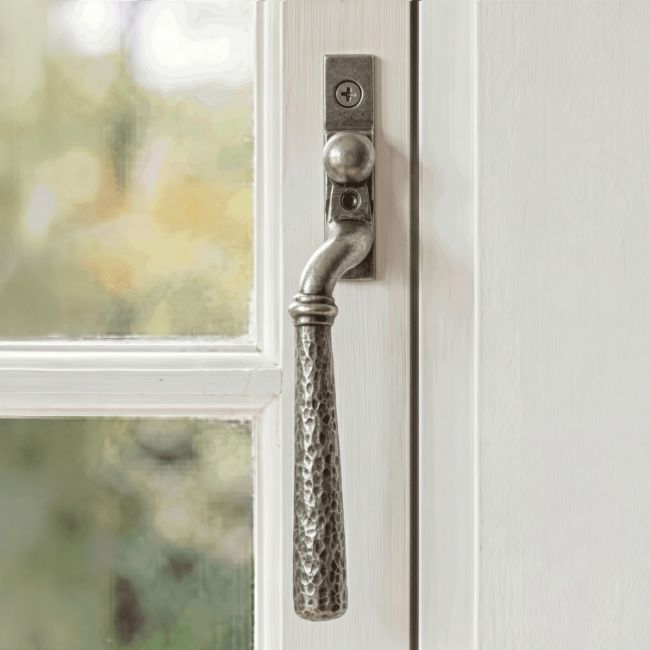 The Right Hand 16mm Hammered Pewter Espagnolette Window Handle on a White Painted Window Frame - Digital Illustration 