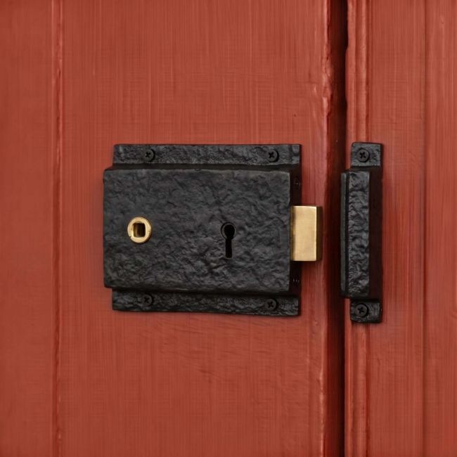 The Left Handed "Almerry" Black Iron Rim Lock on an Orange Door to a Country Home - Digital Illustration The Left Handed "Almerry" Black Iron Rim Lock on an Orange Door to a Country Home - Digital Illustration