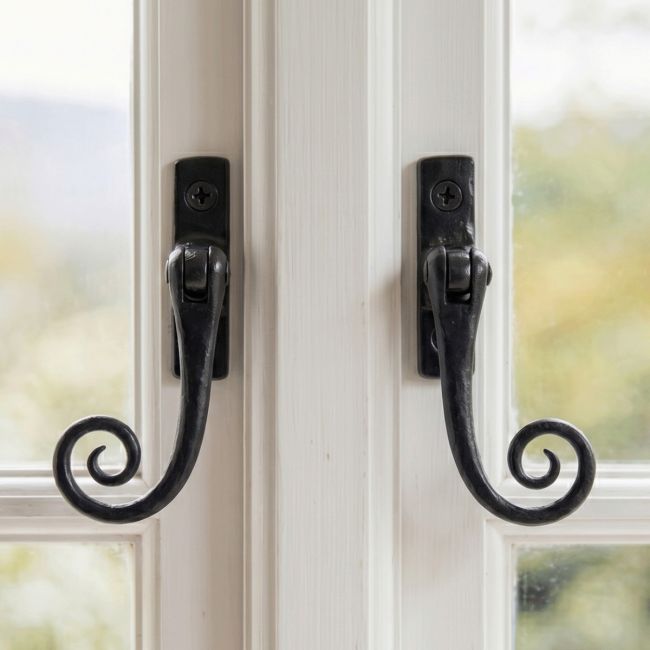 The Left Handed and Right Handed Black Iron Monkeytail Casement Fastener With Espagnolette on a Wooden White Window Frame - Digital Illustration
