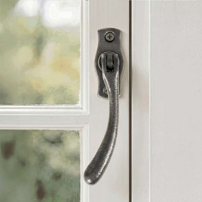 The Left Handed Antique Pewter Peardrop Window Handle Mounted on a Traditional White Window Frame - Digital Illustration The Left Handed Antique Pewter Peardrop Window Handle Mounted on a Traditional White Window Frame - Digital Illustration