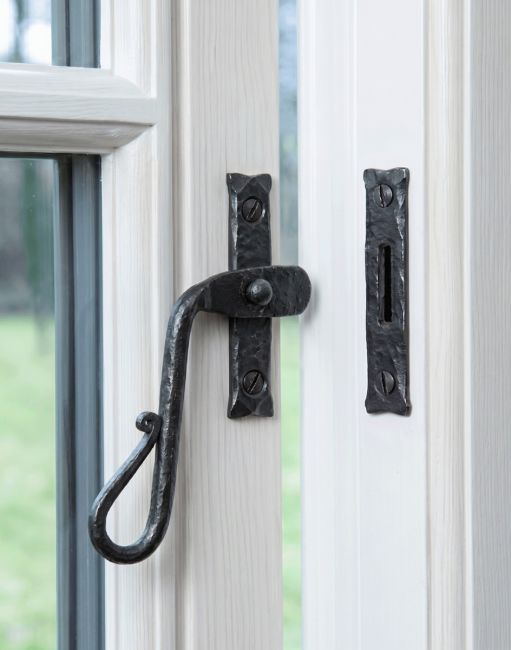 The Left Handed Bees Wax Shepherds Crook Window Fastener Mounted on a White Painted Window Frame - Digital Illustration 