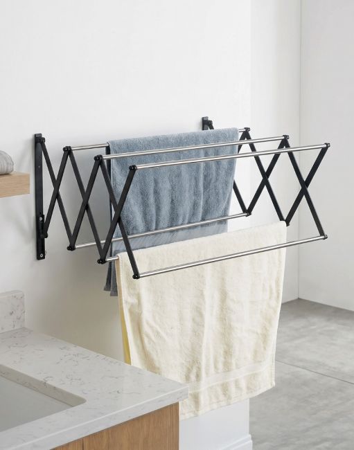 The Lindham Spacesaving Foldaway Towel Rack Mounted on a Wall Next to a Bath - Digital Illustration The Lindham Spacesaving Foldaway Towel Rack Mounted on a Wall Next to a Bath - Digital Illustration