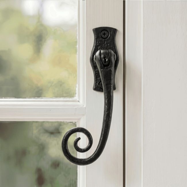 The Lockable Left Hand 3 Point Black Iron Window Fastener With Monkey Tail Fitted on a Painted White Window Frame - Digital Illustration