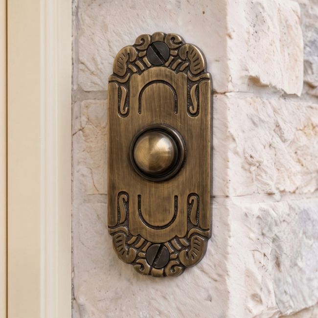 Art Nouveau inspired door bell on brick wall Art Nouveau inspired door bell on brick wall