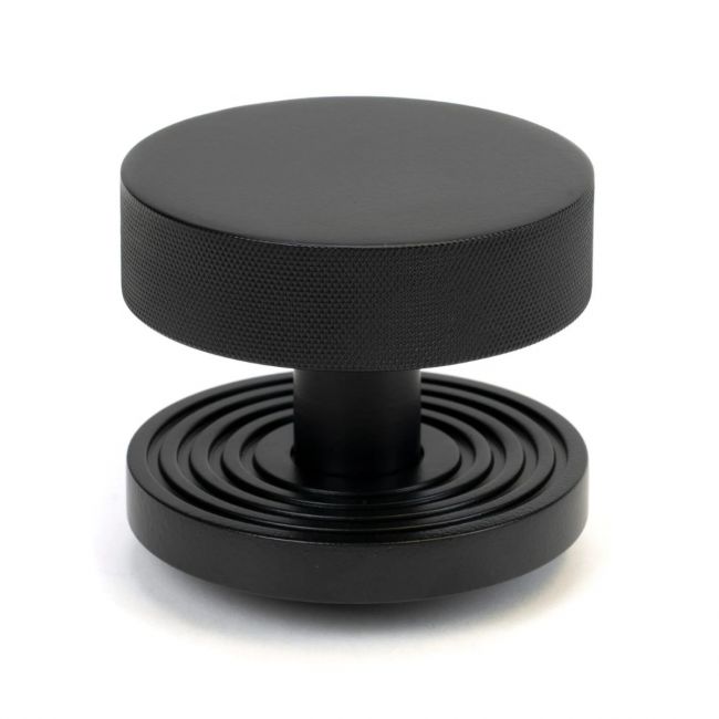 The Matt Black Knurled Centre Door Knob on a Beehive Rose Shown Upright on a White Background The Matt Black Knurled Centre Door Knob on a Beehive Rose Shown Upright on a White Background