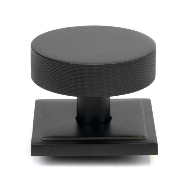 The Matt Black Knurled Centre Door Knob on a Square Rose Shown Upright on a White Background The Matt Black Knurled Centre Door Knob on a Square Rose Shown Upright on a White Background