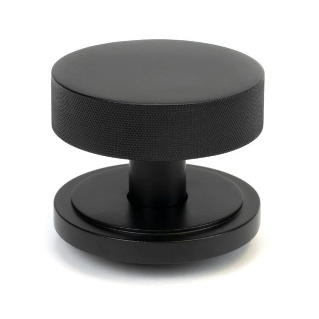 The Matt Black Knurled Centre Door Knob on an Art Deco Rose Shown Upright on a White Background The Matt Black Knurled Centre Door Knob on an Art Deco Rose Shown Upright on a White Background