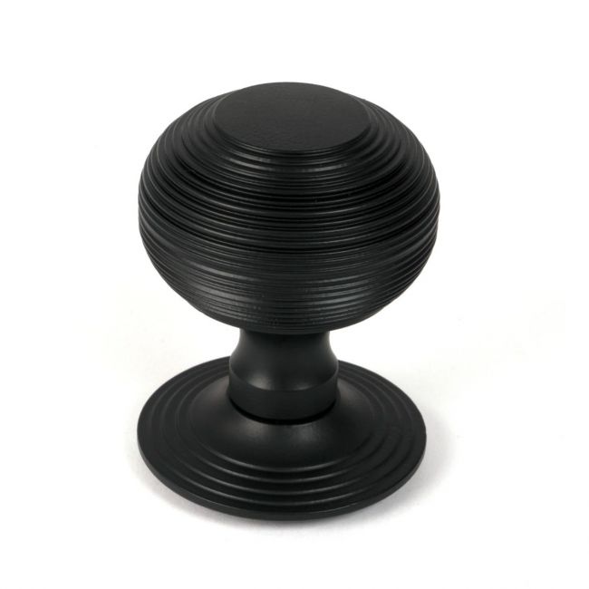 The Matt Black Traditional Beehive Centre Door Knob Shown Upright on a White Background 