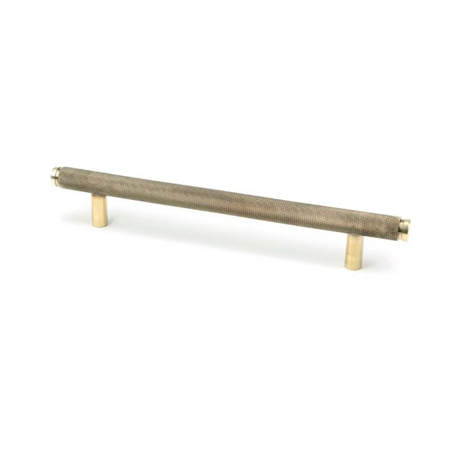The Medium Knurled Cabinet Pull Handle in Aged Brass Shown Upright on a White Background