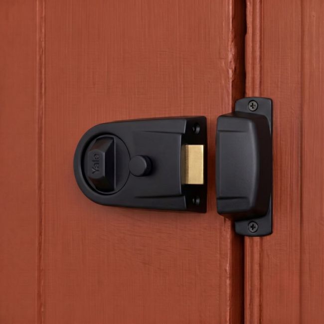 The Modern Rim Nightlatch with Cylinder Lock in a Matte black and Brass Finish Fitted on a Contemporary Wooden Door - Digital Illustration 