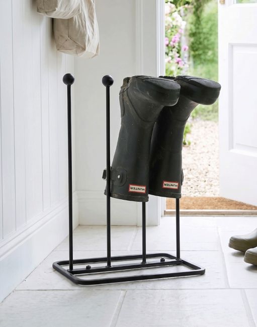 The Oxford Lacquered Steel Two Pair Boot Rack Placed on a Cream Tile Floor - Digital Illustration 