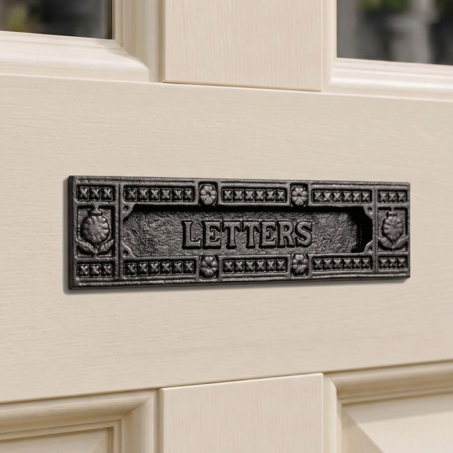 The Patterned Black Iron Letter Plate on a Wooden Door with Glass Windows - Digital Illustration The Patterned Black Iron Letter Plate on a Wooden Door with Glass Windows - Digital Illustration