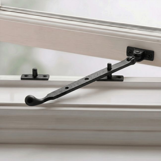 The Pear Drop End Cast Iron Window Stay Fixed on a White Wooden Window Frame - Digital Illustration 