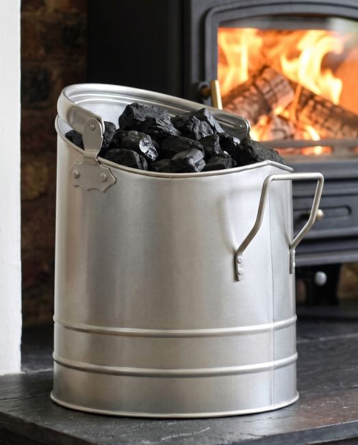 The Pewter Finish Traditional Fireside Log and Coal Bucket In Front of a Lit Fireplace in a Contemporary Home - Digital Illustration The Pewter Finish Traditional Fireside Log and Coal Bucket In Front of a Lit Fireplace in a Contemporary Home - Digital Illustration