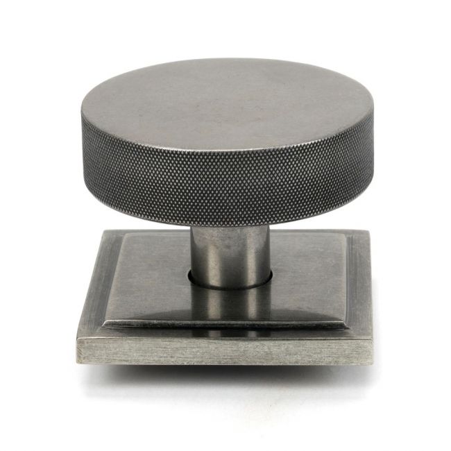 The Pewter Knurled Centre Door Knob on a Square Rose Shown Upright on a White Background The Pewter Knurled Centre Door Knob on a Square Rose Shown Upright on a White Background