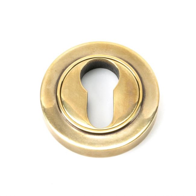 The Plain Concealed Standard Euro Escutcheon - Aged Brass on a White Background The Plain Concealed Standard Euro Escutcheon - Aged Brass on a White Background