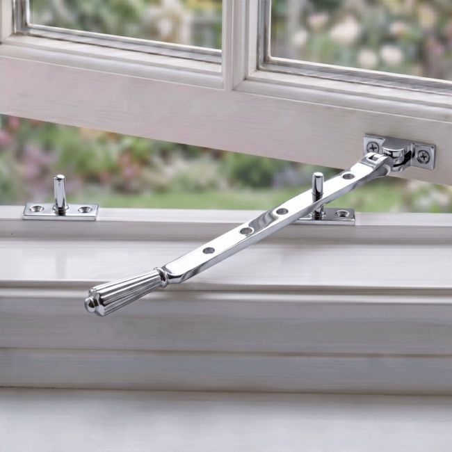 The 8 Inch Polished Chrome Georgian Reeded Casement Window Stay on a White Background The 8 Inch Polished Chrome Georgian Reeded Casement Window Stay on a White Background