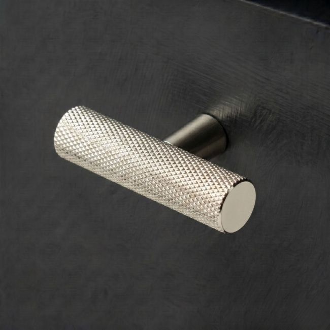 The Matt Black "Astor" Knurled Industrial T-Bar Cabinet Handle Mounted on a light Green Kitchen Cupboard Drawer - Digital Illustration