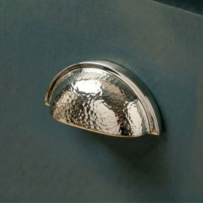 The Polished Nickel Curved Drawer Pull with Hammered Handle Fitted on a Contemporary Kitchen Cupboard Drawer - Digital Illustration The Polished Nickel Curved Drawer Pull with Hammered Handle Fitted on a Contemporary Kitchen Cupboard Drawer - Digital Illustration