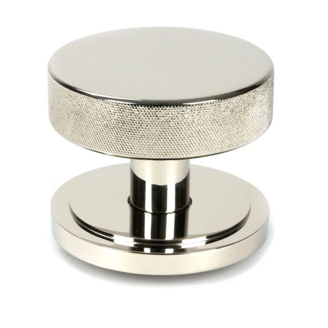 The Polished Nickel Knurled Centre Door Knob on Art Deco Rose Shown Upright on a White Background The Polished Nickel Knurled Centre Door Knob on Art Deco Rose Shown Upright on a White Background