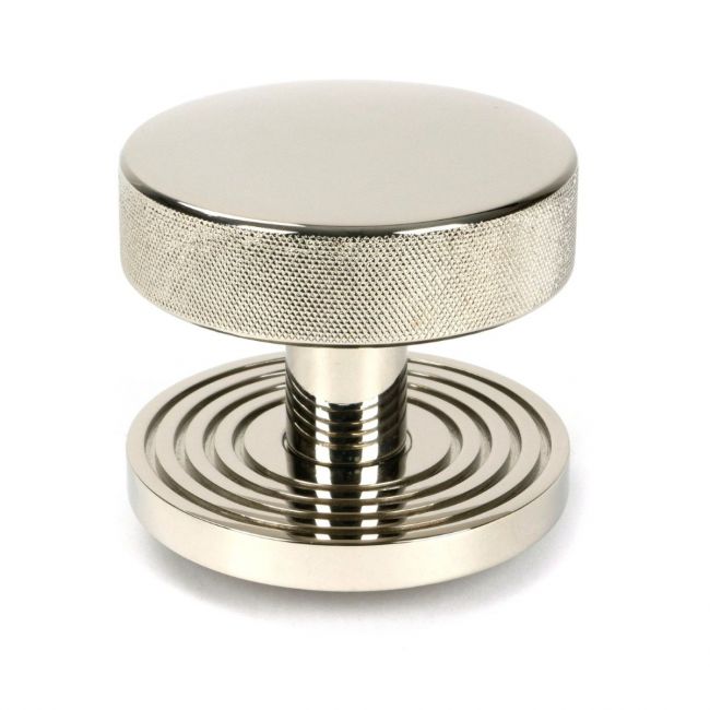 The Polished Nickel Knurled Centre Door Knob on Beehive Rose Shown Upright on a White Background The Polished Nickel Knurled Centre Door Knob on Beehive Rose Shown Upright on a White Background
