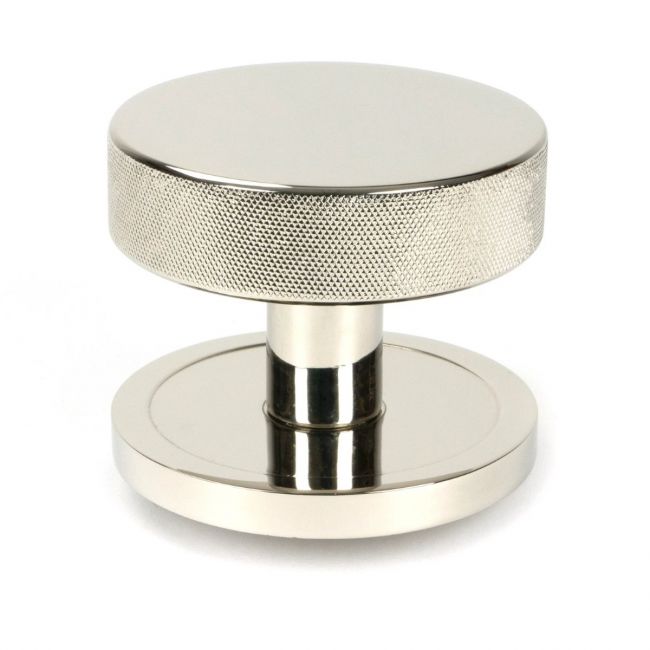 The Polished Nickel Knurled Centre Door Knob on Plain Rose Shown Upright on a White Background The Polished Nickel Knurled Centre Door Knob on Plain Rose Shown Upright on a White Background