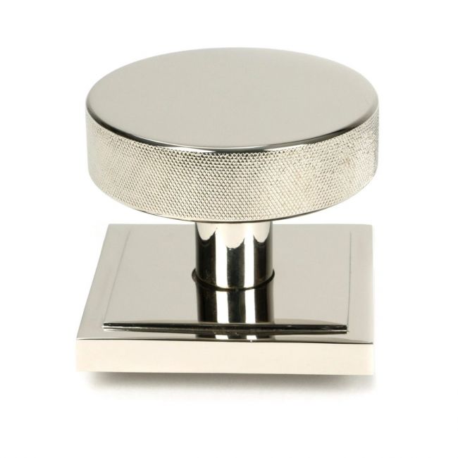 The Polished Nickel Knurled Centre Door Knob on Square Rose Shown Upright on a White Background The Polished Nickel Knurled Centre Door Knob on Square Rose Shown Upright on a White Background