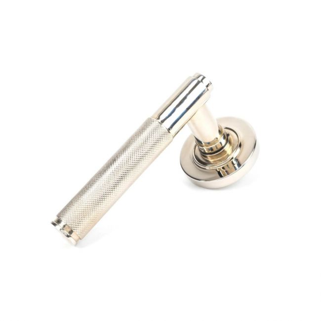 The Polished Nickel Knurled Lever on Plain Rose Set on a White Background The Polished Nickel Knurled Lever on Plain Rose Set on a White Background