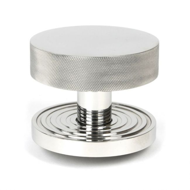 The Polished Stainless Steel Knurled Centre Door Knob on a Beehive Rose Shown Upright on a White Background The Polished Stainless Steel Knurled Centre Door Knob on a Beehive Rose Shown Upright on a White Background