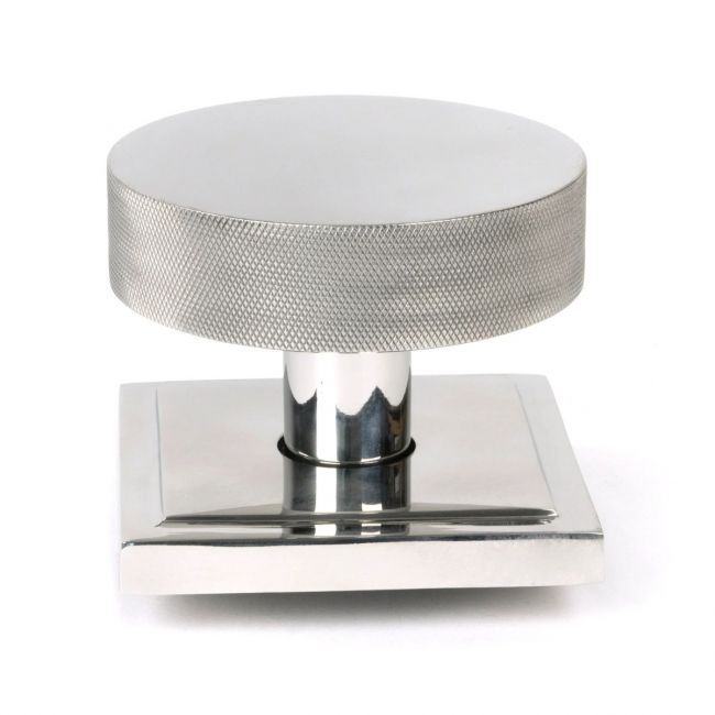 The Polished Stainless Steel Knurled Centre Door Knob on a Square Rose Shown Upright on a White Background The Polished Stainless Steel Knurled Centre Door Knob on a Square Rose Shown Upright on a White Background