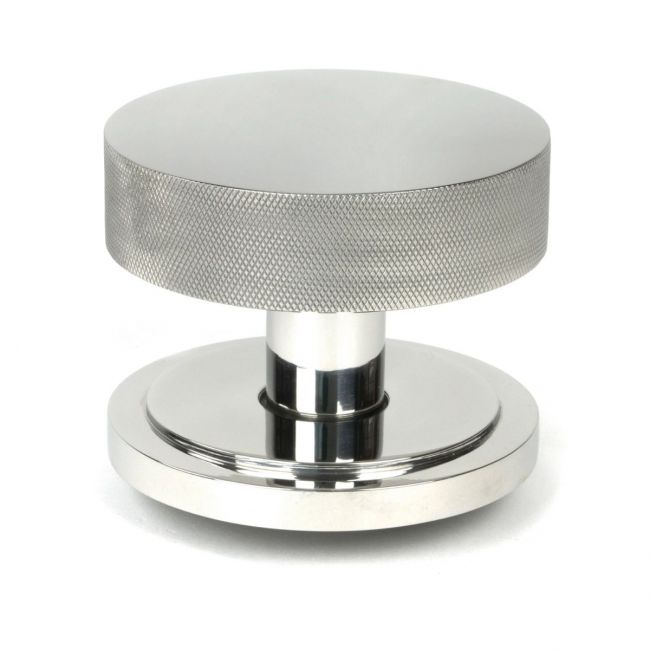 The Polished Stainless Steel Knurled Centre Door Knob on an Art Deco Rose Shown Upright on a White Background The Polished Stainless Steel Knurled Centre Door Knob on an Art Deco Rose Shown Upright on a White Background