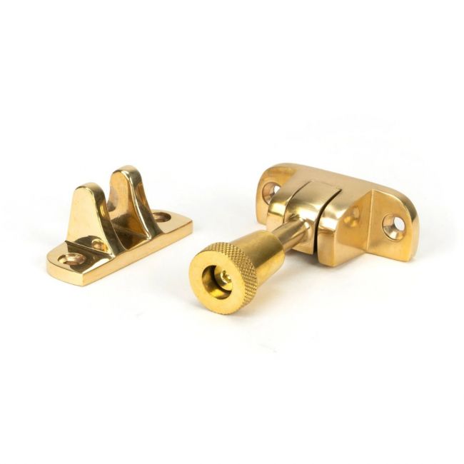 The Radiused Knurled Brighton Sash Window Fastener in Polished Brass on a White Background The Radiused Knurled Brighton Sash Window Fastener in Polished Brass on a White Background
