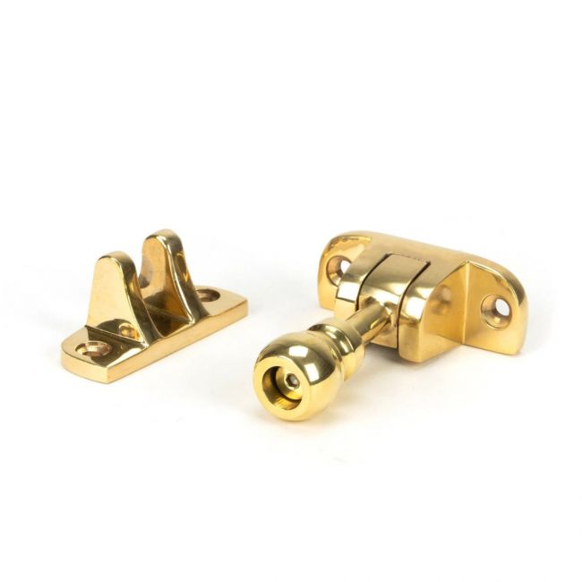 The Radiused Rounded Brighton Sash Window Fastener in Polished Brass on a White Background The Radiused Rounded Brighton Sash Window Fastener in Polished Brass on a White Background