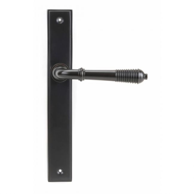 The Reeded Slimline Lever Espagnolette Door Latch in Aged Bronze on a White Background The Reeded Slimline Lever Espagnolette Door Latch in Aged Bronze on a White Background