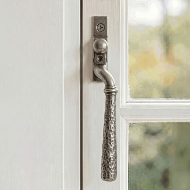 The Right Hand 16mm Hammered Pewter Espagnolette Window Handle on a White Painted Window Frame - Digital Illustration 