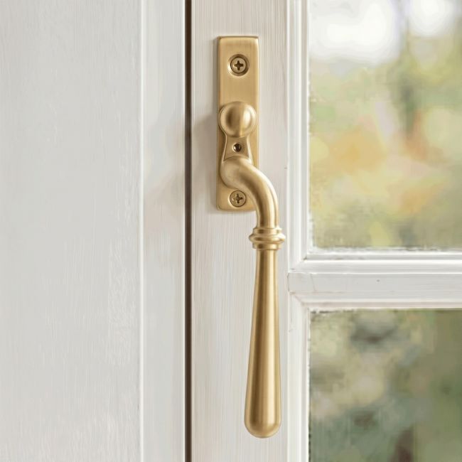 The Right Handed 16mm Modern Satin Brass Espagnolette Window Handle Mounted on a Classic White Coloured Window Frame in a Country Home - Digital Illustration 