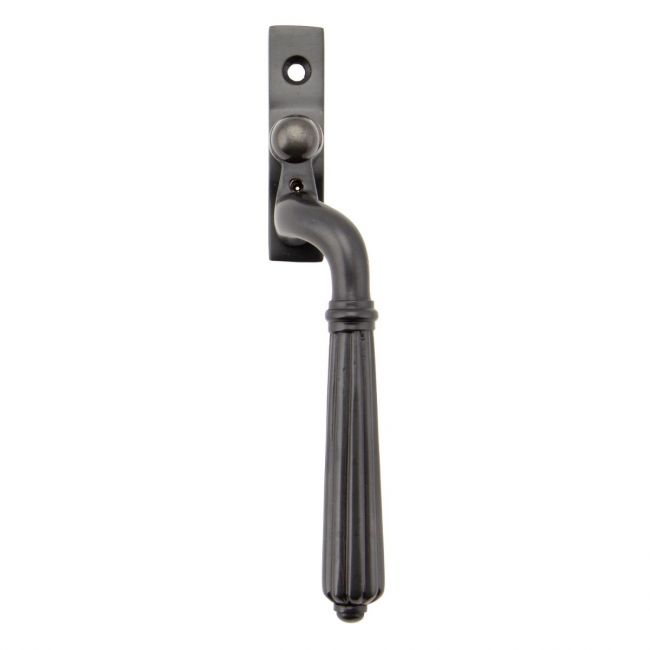 The Right Handed Aged Bronze Reeded Georgian Espagnolette Window Handle on a White Background The Right Handed Aged Bronze Reeded Georgian Espagnolette Window Handle on a White Background